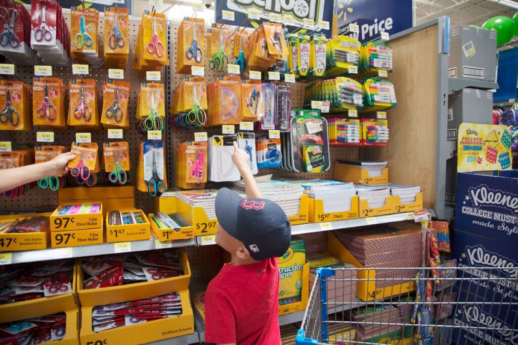 Couponing At Walmart - A child choosing school supplies.